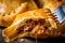 Close-up of empanada dough being crimped with a fork, revealing the moist and juicy meat filling inside