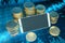 Close up of empty mock up smart phone with stacked coins on abstract blue forex chart background. Online banking, trade,