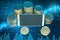 Close up of empty mock up smartphone with stacked coins on abstract blue forex chart background. Online banking, trade,