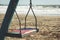 Close up on empty old rusty swing on beach in La Serena