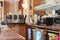 Close-up of empty vintage marble restaurant bar counter with coffee machine, microwave oven, glasses shelf