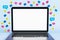 Close up of empty white mock up laptop screen with colorful social media icons on light background. Communication, follow and