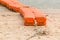 Close up end of orange sea buoys tied on sea beach, marine equip