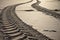 Close up of engine tyre trace on a sandy beach in early morning