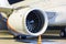 Close-up of engine of white passenger airplane at night