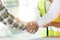 Close up engineer shaking hand with building contractor in construction site , successful negotiate of manager and industrial