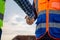 Close up of Engineers shaking hands at construction site, Construction worker in protective uniform shaking hands with businessman