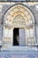 Close-up of the entrance to the Gothic Cathedral of Saints Peter and Paul in Visegrad. door and portal flanked with magnificent mo