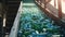 Close-up of Escalator with a pile of plastic bottles at the factory for processing and recycling. Recycling plant