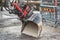 Close up of excavator, grader or tractor bucket, city road renovation at the background