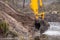 Close up on excavator scoop digging pond