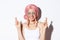 Close-up of excited girl with pink wig, making wish with fingers crossed, smiling hopeful, wearing halloween costume