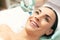 Close up of excited woman enjoying skin nourishing procedure