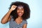 Close up excited young african american woman with curly hair wearing glasses on blue background
