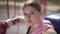 Close-up exhausted female boxer rubbing forehead with boxing gloves and looking at camera. Beautiful motivated confident