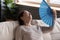 Close up exhausted middle aged woman waving paper fan