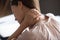 Close up exhausted woman touching massaging tensed neck muscles