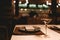 Close up of exquisite glass of champagne stands on table in restaurant, next to empty plate with cutlery and napkin. White wine on