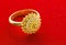 Close up Exquisite Gold Ring on Red Velvet