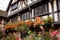 close-up of the exterior of a tudor house, with richly colored flowers in bloom
