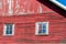 Close up exterior view of old weathered red 19th Century wooden barn