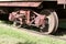 Close up exterior view of the wheels under an old 19th Century railroad train boxcar