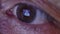 Close-up eye of an elderly man watching the news