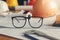 Close up eyeglasses with blueprints and house model background