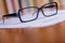 Close up Eyeglasses on Top of White Papers