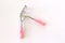 Close-up the Eyelash curler with pink handles for woman eyes on