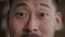 A close-up of the eyes of an Asian man getting surprised and his eyebrows rising in surprise