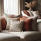 Close up of fabric sofa with white and terra cotta pillows. French country home interior design of modern living room