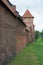 Close up of facade of Malbork castle. High walls, no people. Poland