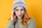 Close up face of beautiful young woman looking at camera, isolated on yellow background. Front view head shot of cute girl