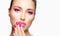 Close-up face of beauty model with colorful pink make-up. Fashion makeup and cosmetics concept