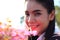 Close up face,caucasian woman and expression happiness,pretty girl with pink cosmos flowers