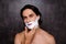 Close up of face of cheerful mulatto hispanic man with white foam on his face, isolated on grey background, so hot, nude chest, b