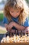 Close up face of clever smart child. Chess strategy. Kid playing chess. Chess, success and winning.