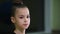 Close-up face of cute beautiful baby girl rhythmic gymnast in gym