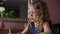 Close-up of face of cute curly little girl drawing at the table