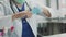 Close-up without a face. A doctor with a stethoscope around his neck removes latex medical gloves at a desk in the