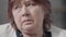 Close-up face of frustrated depressed senior Caucasian woman thinking looking around. Headshot of sad lonely unhappy