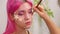 Close-up face of a girl with sea stars glued to her face in the process of applying makeup to the skin.