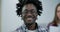 Close-up face of happy African American man in eyeglasses looking at camera and smiling. Portrait of cheerful confident