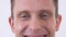 Close up face of happy smilling man looking in camera isolated on a white background.