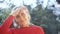 Close up face of happy smilling senior woman with grey hair blessing someone during sunny day outdoors