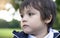 Close up face of litte boy with running nose, Child having allergy, tchy eyes and nose after playing in the park, kid has