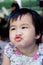 Close up face of lovely and cute asian baby making funny mouth