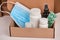 Close-up on face mask, bottles, blister of pills and spray being packed