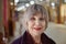 Close up face of mature smiling caucasian woman in shopping mall interior